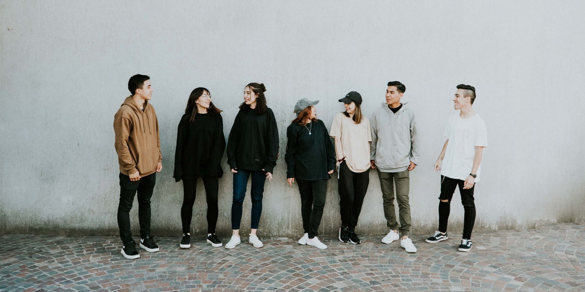 A group of youth by a wall