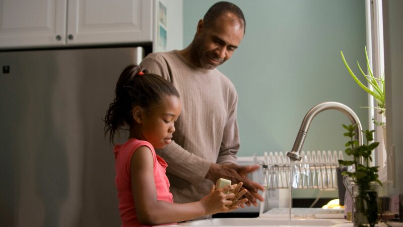 Father and daughter washing hands
