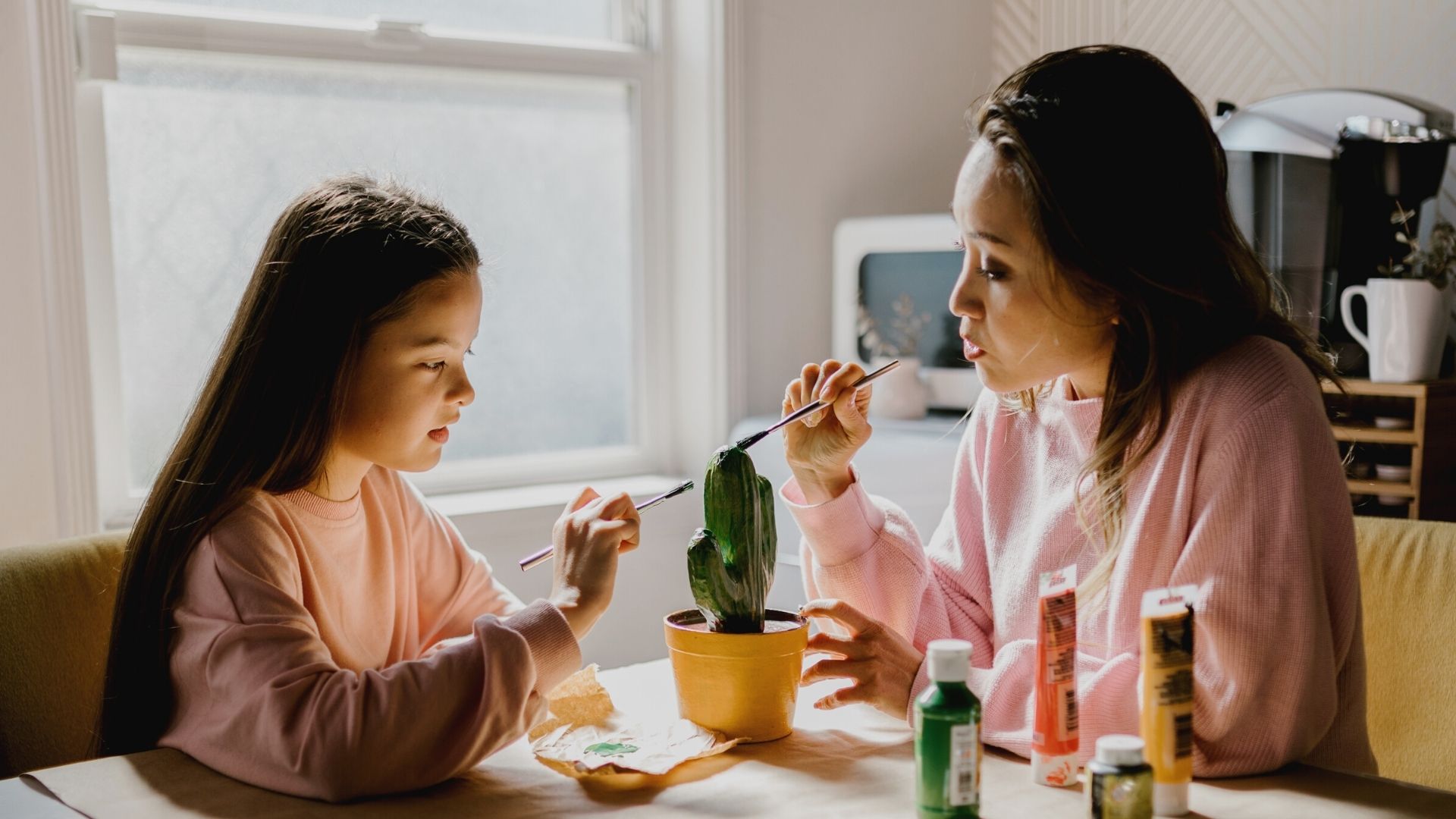 Mother and daughter painting a cactus