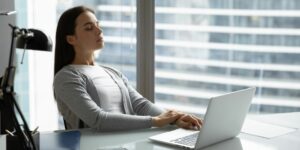Woman practicing mindful breathing during work